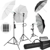 Studio lighting kit with three lights on tripods, two with translucent umbrella diffusers and one with a silver umbrella reflector.